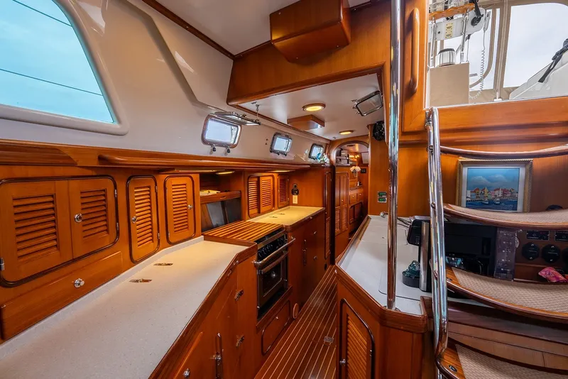 Slide: The Image of Luxurious interior of 2008 Passport Vista 515 Center Cockpit yacht with wooden cabinetry and modern amenities. - 24