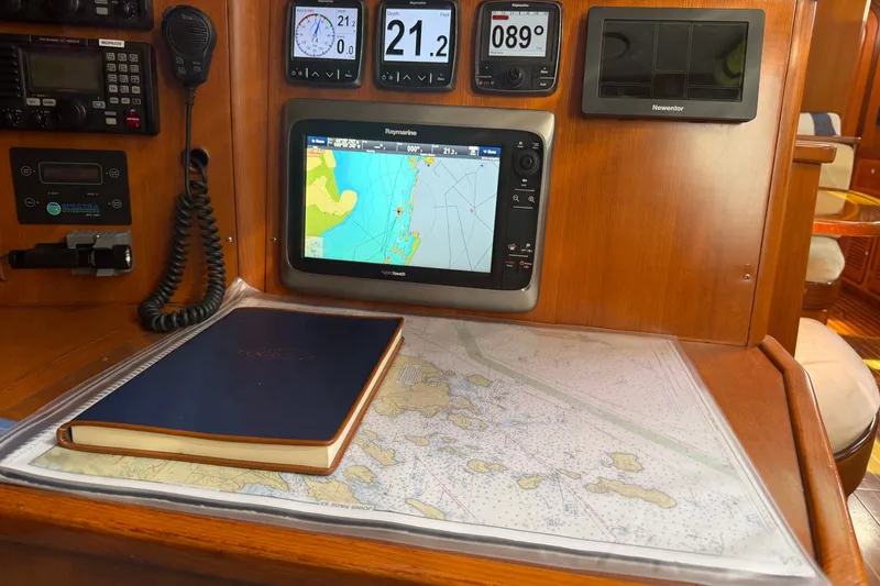 Slide: The Image of Navigation station on 2008 Passport Vista 515 Center Cockpit with charts and instruments. - 13