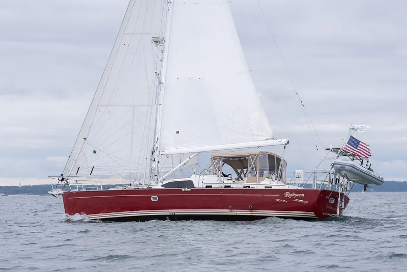 Slide: The Image of Sailing yacht Passport Vista 515 Center Cockpit, 2008, with red hull and white sails on open water. - 7