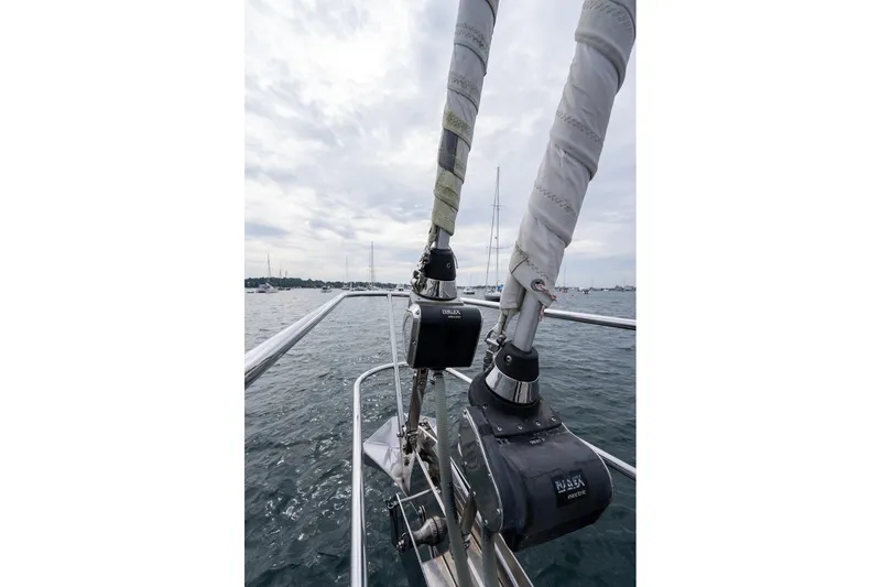 Slide: The Image of Sailboat rigging on a 2008 Passport Vista 515 Center Cockpit, with a cloudy sky backdrop. - 35