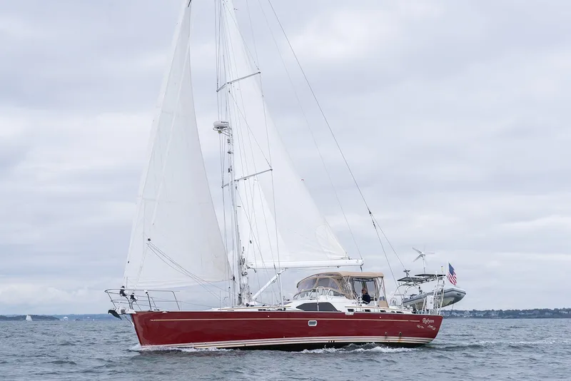 Slide: The Image of Sailing yacht Passport Vista 515 Center Cockpit, 2008 model, with red hull on open water. - 8