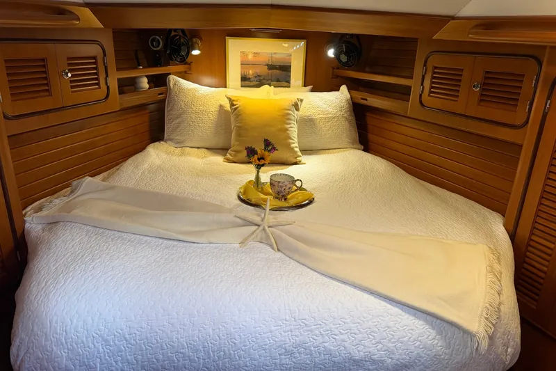 Slide: The Image of Cozy cabin bedroom in 2008 Passport Vista 515 Center Cockpit yacht, featuring elegant wood paneling. - 16