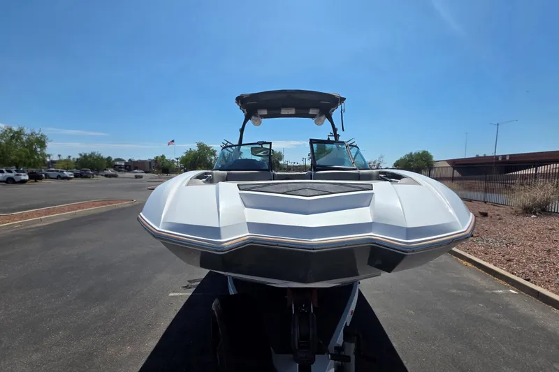 Slide: The Image of 2018 Supra SA 400 boat parked outdoors on a sunny day. - 6