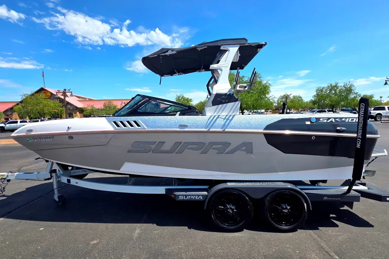 Slide: The Image of 2018 Supra SA 400 boat on trailer under clear blue sky. - 8