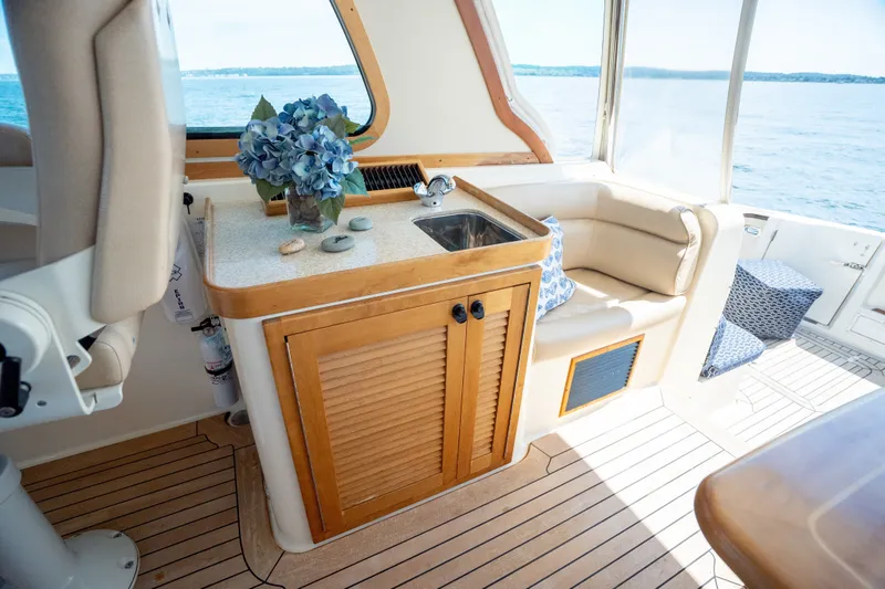 Slide: The Image of Interior of 2008 Sabre 42 Hard Top Express yacht with seating, sink, and ocean view. - 17
