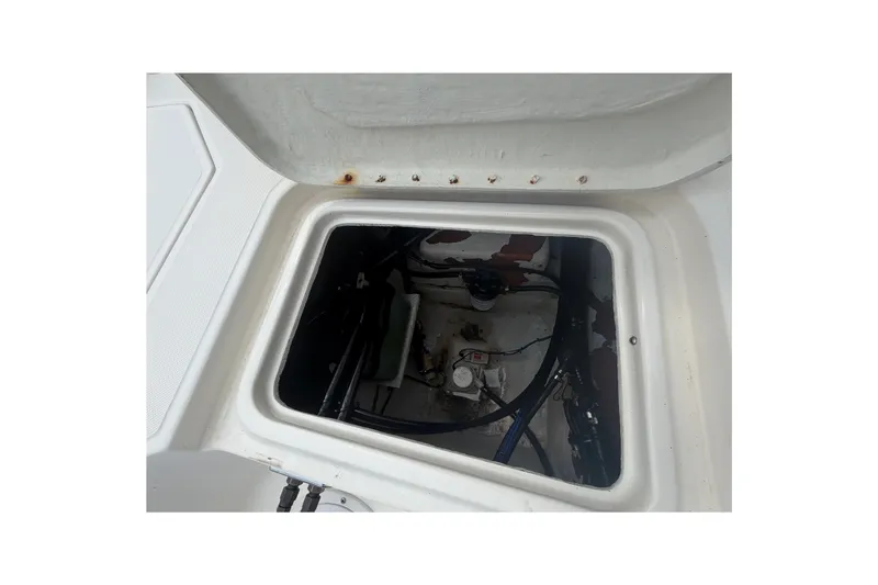Slide: The Image of Open hatch of a 1999 Hydra-Sports 20 Bay Sport boat, showing internal components. - 30