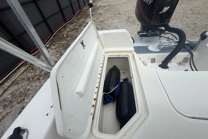 Slide: The Image of Open storage compartment on 1999 Hydra-Sports 20 Bay Sport boat with fenders inside. - 29