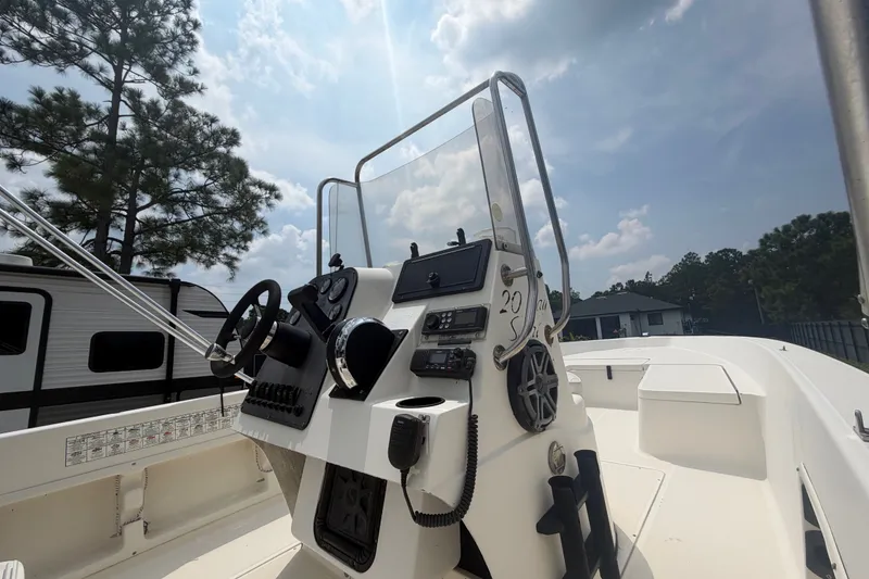 Slide: The Image of 1999 Hydra-Sports 20 Bay Sport boat console with steering wheel and controls under a sunny sky. - 27