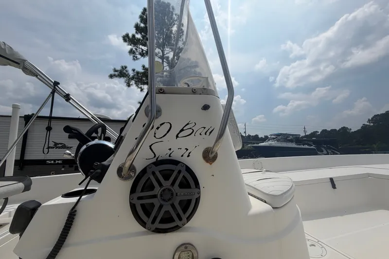 Slide: The Image of 1999 Hydra-Sports 20 Bay Sport boat console with speaker, under a partly cloudy sky. - 28