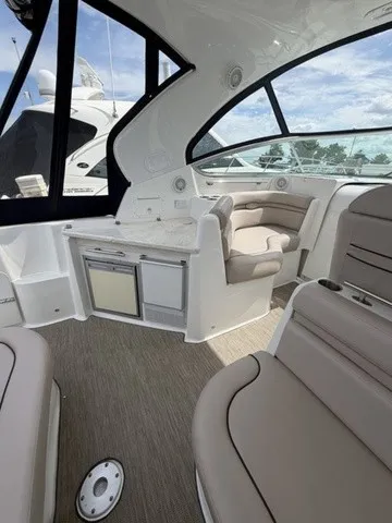 Slide: The Image of Interior of a 2015 Rinker 360 Express Cruiser with sleek seating and panoramic windows. - 6