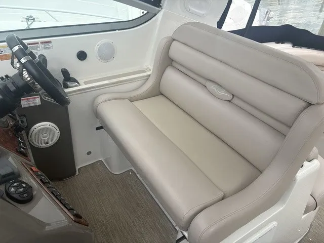Slide: The Image of The image shows the helm of a 2015 Rinker 360 Express Cruiser with a beige seat. - 12