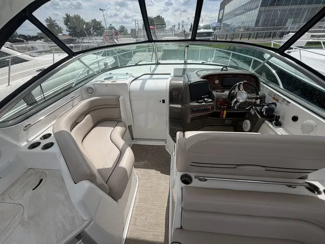Slide: The Image of The image shows the cockpit of a 2015 Rinker 360 Express Cruiser with beige seating. - 7