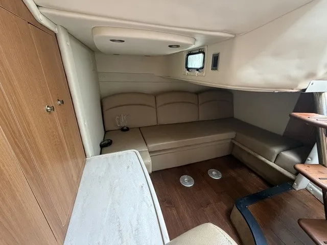 Slide: The Image of Interior of the 2015 Rinker 360 Express Cruiser with seating area and wooden floor. - 16