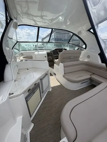Slide: The Image of Interior of a 2015 Rinker 360 Express Cruiser with beige seating and modern amenities. - 4