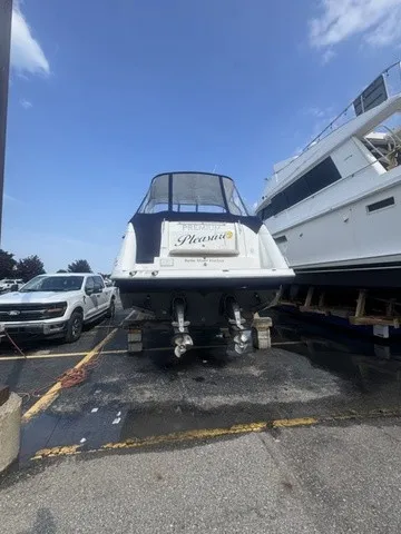Slide: The Image of 2015 Rinker 360 Express Cruiser on a parking lot, with other boats in the background. - 21