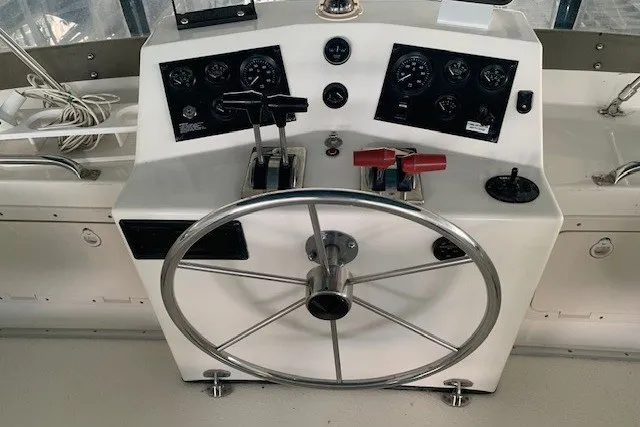 Slide: The Image of Control panel of a 1993 Harbor Master 450 Coastal Cruiser with steering wheel and gauges. - 18