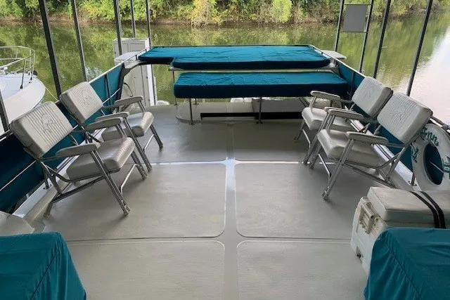 Slide: The Image of Spacious deck of 1993 Harbor Master 450 Coastal Cruiser with seating and river view. - 17