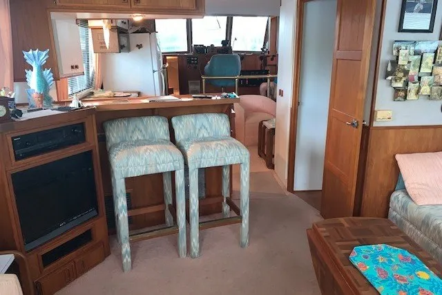 Slide: The Image of Interior of a 1993 Harbor Master 450 Coastal Cruiser with bar stools and cozy seating area. - 35