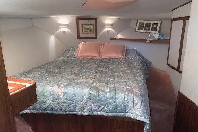 Slide: The Image of Cozy bedroom in 1993 Harbor Master 450 Coastal Cruiser with quilted bedding and framed art. - 23