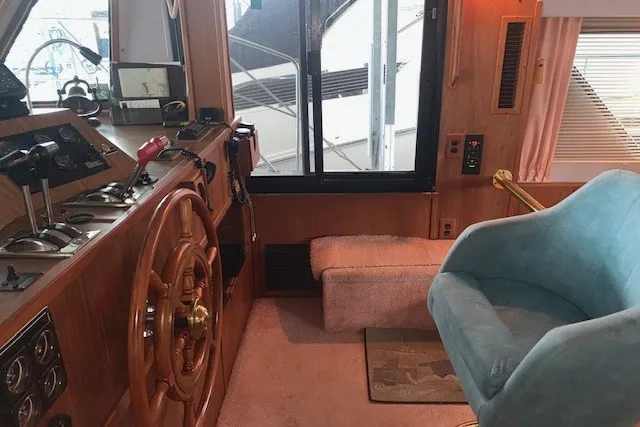 Slide: The Image of Interior of 1993 Harbor Master 450 Coastal Cruiser with helm and blue chair. - 21