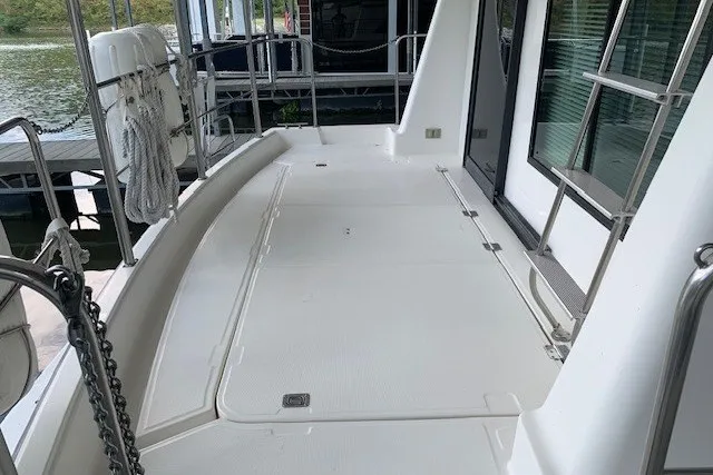 Slide: The Image of 1993 Harbor Master 450 Coastal Cruiser deck, featuring spacious white surface and railing. - 13