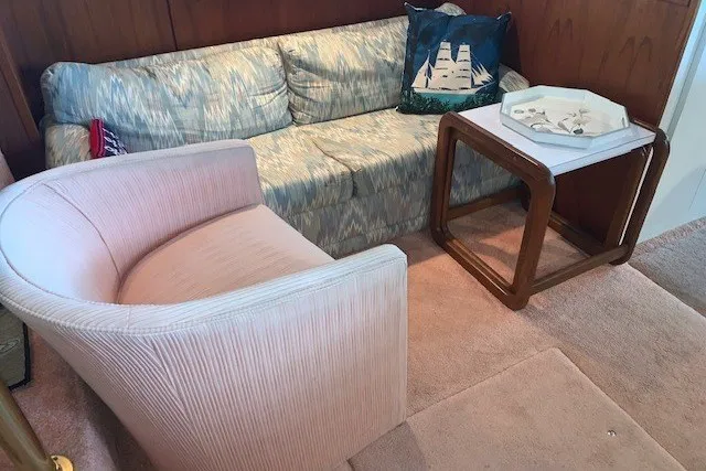 Slide: The Image of Interior of 1993 Harbor Master 450 Coastal Cruiser with sofa, chair, and wooden table. - 29