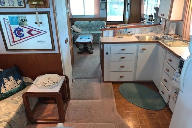 Slide: The Image of Interior of 1993 Harbor Master 450 Coastal Cruiser with cozy seating and compact kitchen area. - 31