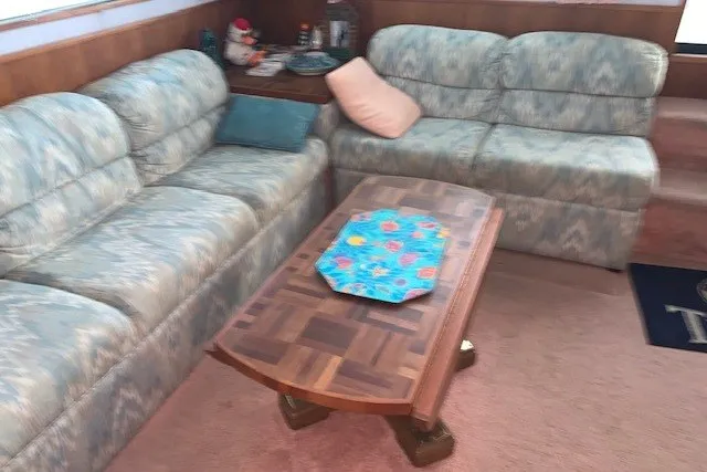 Slide: The Image of Interior of 1993 Harbor Master 450 Coastal Cruiser with patterned sofas and wooden coffee table. - 36