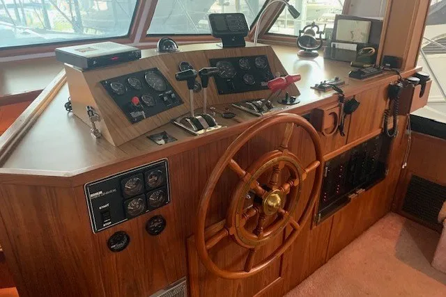 Slide: The Image of 1993 Harbor Master 450 Coastal Cruiser helm with wooden wheel and control panel. - 20
