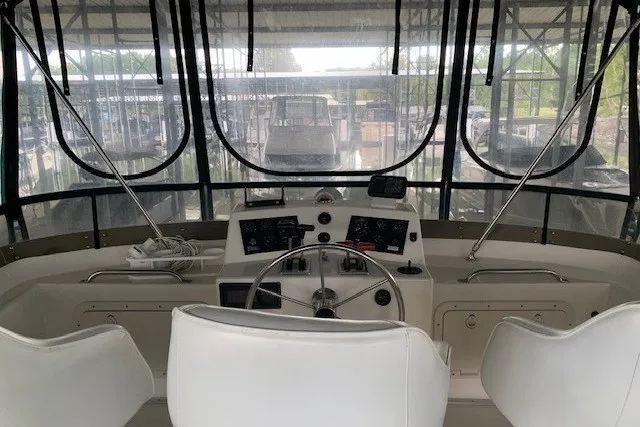 Slide: The Image of Cockpit of 1993 Harbor Master 450 Coastal Cruiser with steering wheel and navigation instruments. - 19
