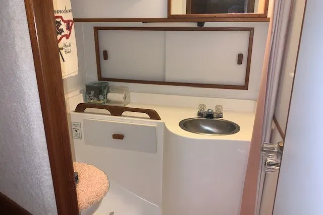 Slide: The Image of Bathroom interior of 1993 Harbor Master 450 Coastal Cruiser with sink and storage. - 25