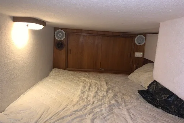 Slide: The Image of Cozy cabin interior of 1993 Harbor Master 450 Coastal Cruiser with wood paneling and bedding. - 27