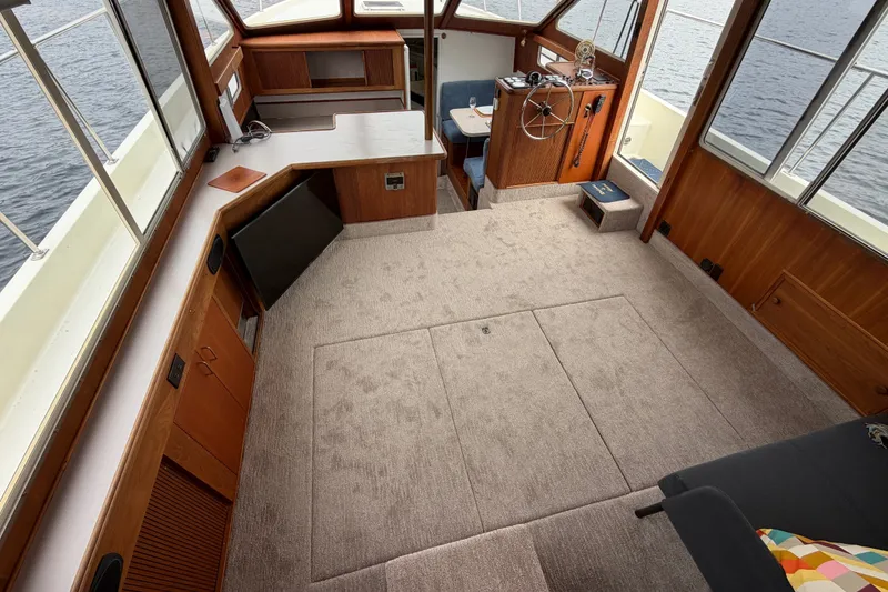 Slide: The Image of 1988 Tollycraft 44 Cockpit Motor Yacht interior with spacious carpeted cabin and helm. - 22