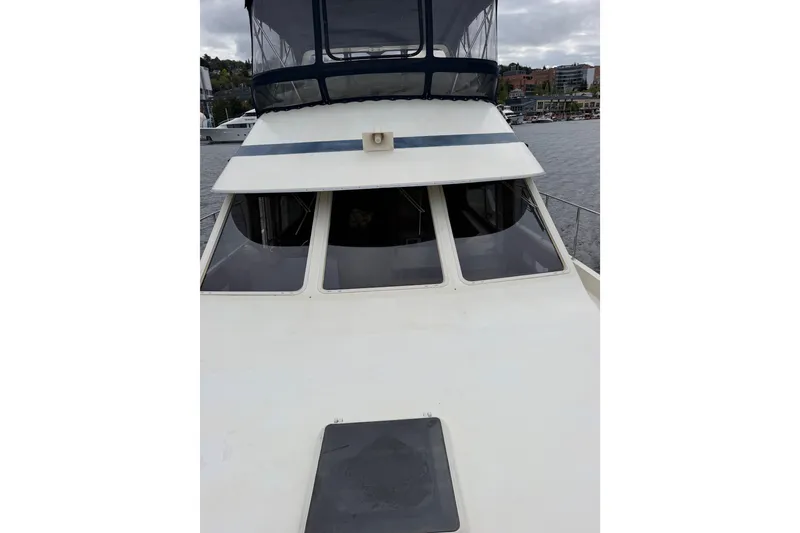 Slide: The Image of 1988 Tollycraft 44 Cockpit Motor Yacht with enclosed flybridge on a cloudy day. - 8