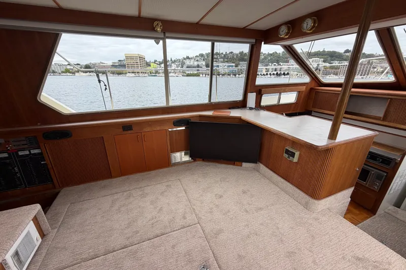 Slide: The Image of 1988 Tollycraft 44 Cockpit Motor Yacht interior with panoramic waterfront views. - 23