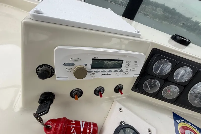 Slide: The Image of Control panel of a 1988 Tollycraft 44 Cockpit Motor Yacht with gauges and marine radio. - 19