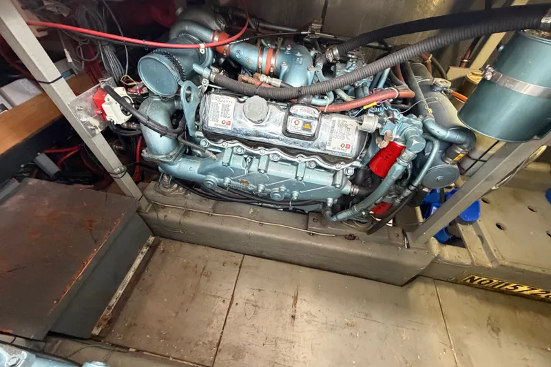 Slide: The Image of Engine compartment of a 1988 Tollycraft 44 Cockpit Motor Yacht, showcasing detailed machinery. - 44