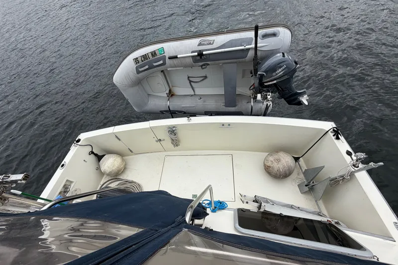 Slide: The Image of 1988 Tollycraft 44 Cockpit Motor Yacht with dinghy and Yamaha outboard motor on water. - 11