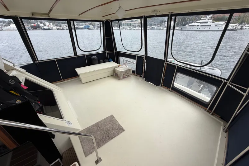 Slide: The Image of 1988 Tollycraft 44 Cockpit Motor Yacht interior with panoramic marina view. - 13