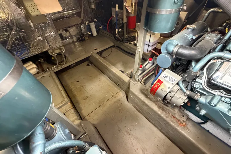 Slide: The Image of Engine room of 1988 Tollycraft 44 Cockpit Motor Yacht, showcasing mechanical components and wiring. - 43