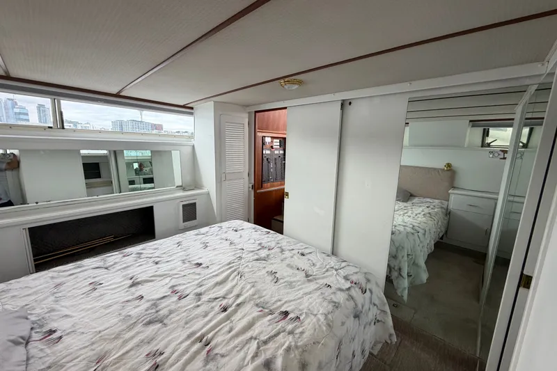 Slide: The Image of Interior of 1988 Tollycraft 44 Cockpit Motor Yacht bedroom with city view. - 40