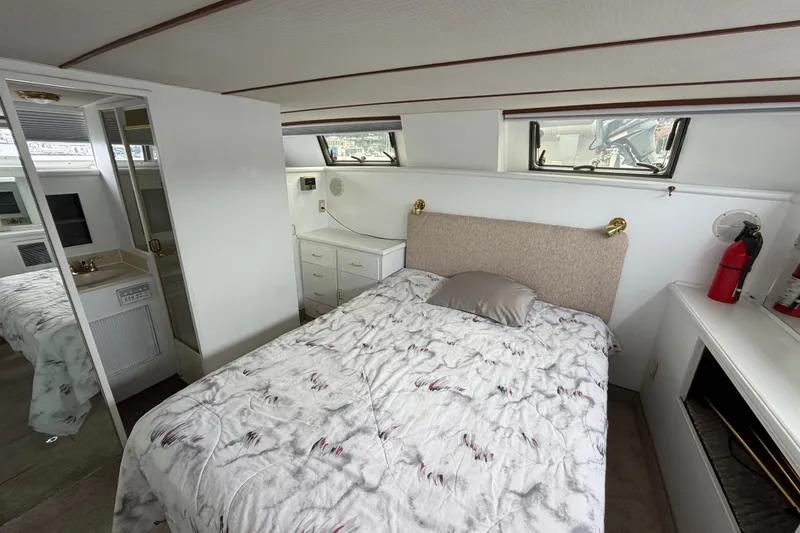 Slide: The Image of Interior of 1988 Tollycraft 44 Cockpit Motor Yacht bedroom with bed and storage. - 37