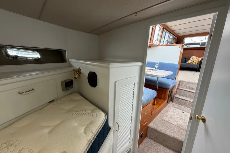 Slide: The Image of Interior of 1988 Tollycraft 44 Cockpit Motor Yacht, featuring cozy cabin and dining area. - 35