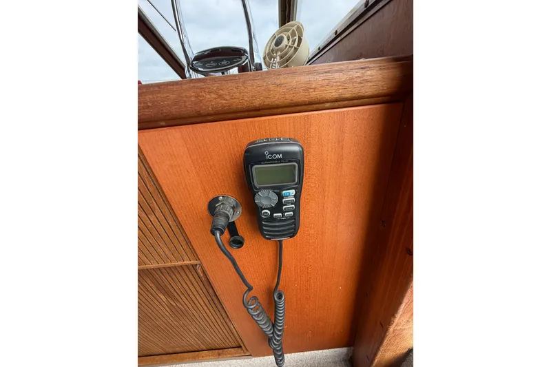 Slide: The Image of ICOM radio on 1988 Tollycraft 44 Cockpit Motor Yacht's wooden dashboard. - 27