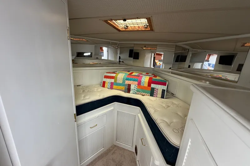 Slide: The Image of 1988 Tollycraft 44 Cockpit Motor Yacht cabin with cozy bed and colorful quilt. - 32
