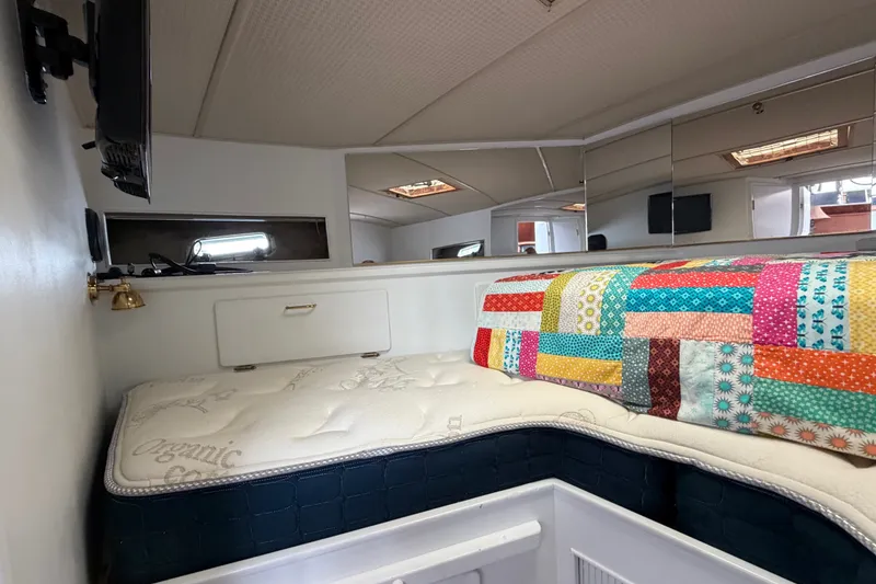 Slide: The Image of Interior of 1988 Tollycraft 44 Cockpit Motor Yacht with colorful quilted bedding. - 33