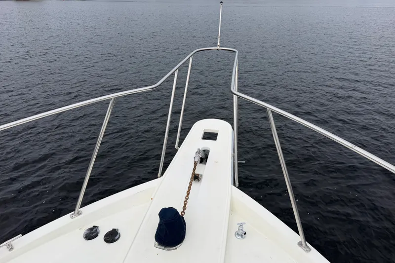 Slide: The Image of Bow view of 1988 Tollycraft 44 Cockpit Motor Yacht on calm water. - 7