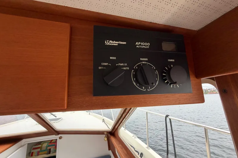 Slide: The Image of Autopilot control panel on 1988 Tollycraft 44 Cockpit Motor Yacht, featuring Robertson AP1000 system. - 28