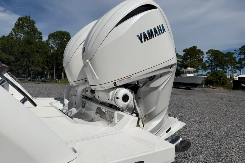 Slide: The Image of 2025 Cobalt R8 Outboard with Yamaha engine, parked outdoors on gravel, surrounded by trees. - 5