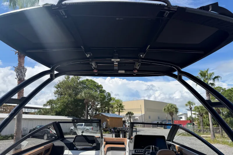 Slide: The Image of 2025 Cobalt R8 Outboard boat interior with canopy, steering wheel, and dashboard. - 19